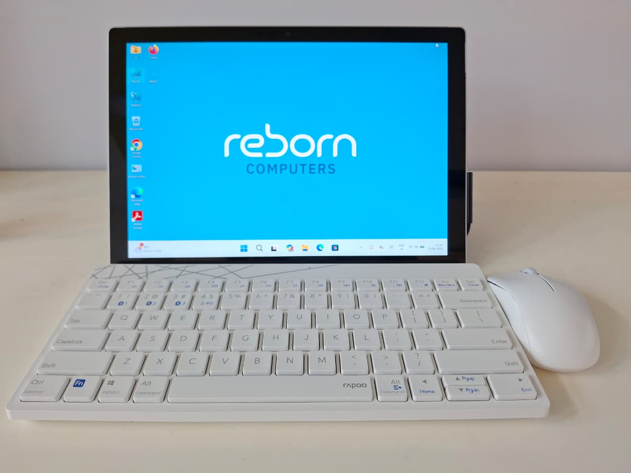 Microsoft Surface Pro with white keyboard and mouse on a table